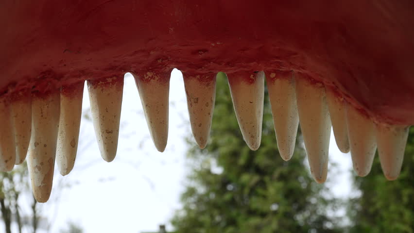 Dangerous animal doll teeth like dinosaur close up. Mouth of predator with powerful teeth to demonstrate strength of animal. View from inside the powerful predatory mouth.