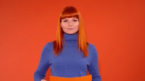 Smiling Woman Pointing at Blank Orange Sign - Powered by Shutterstock - Get 15% off with code: PIKWIZARD15