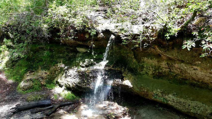 Slow pass over a small waterfall in South Carolina with dappled sunlight