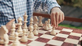 Little boys hand starts chess game with white pawn move. KId begins competition - Powered by Shutterstock - Get 15% off with code: PIKWIZARD15