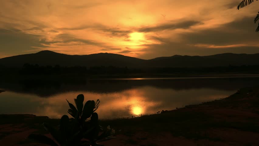  Time-lapse photo of sunset over mountains and lake.