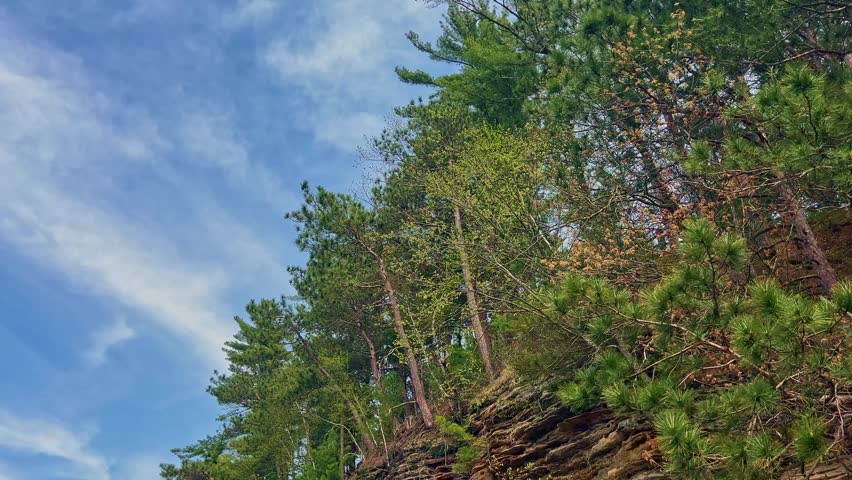 A stunning sunset view from the water at Mirror Lake, Reedsburg, with vibrant skies reflecting off the tranquil lake and dramatic cliffs creating a picturesque scene