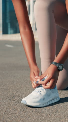 Hands, runner and tie shoes in road to start exercise, running preparation or marathon training in city. Fitness, person and getting ready with sneakers outdoor for cardio workout or race performance