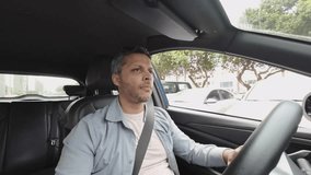 Interior view of a man driving an SUV along a coastal highway during golden hour, with warm light and scenic sea views outside. - Powered by Shutterstock - Get 15% off with code: PIKWIZARD15