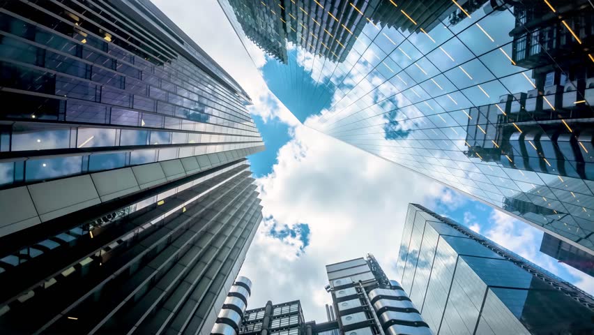 Motion time lapse view of looking directly up at the skyline of the financial district in central London