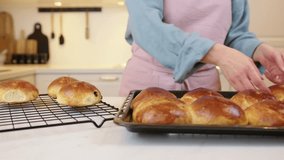 Removing Hot Raisin Buns from Oven and Cooling on Rack - Powered by Shutterstock - Get 15% off with code: PIKWIZARD15