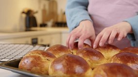 Removing Hot Raisin Buns from Oven and Cooling on Rack - Powered by Shutterstock - Get 15% off with code: PIKWIZARD15