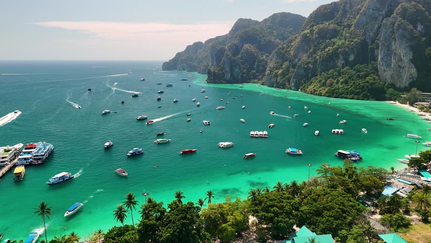 Turquoise water, white sand beaches, boats sailing in Maya bay, Phi Phi island, Thailand.