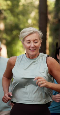 Fitness, running and mature woman in nature for body health, lose weight or marathon race. Cardio, jog and happy group outdoor for exercise, workout and training for sports competition together