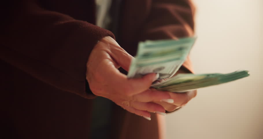 Hands, fraud or woman counting cash for profit, money laundering or investment scam in crime syndicate. Closeup, bank notes or thief with dollars in criminal activity, corruption or illegal business