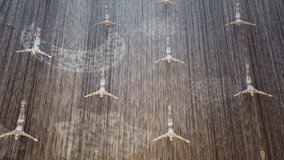 Time-lapse video of the iconic Dubai Mall indoor waterfall featuring human diver sculptures, creating a dramatic visual of motion and elegance inside the world’s largest shopping mall. - Powered by Shutterstock - Get 15% off with code: PIKWIZARD15