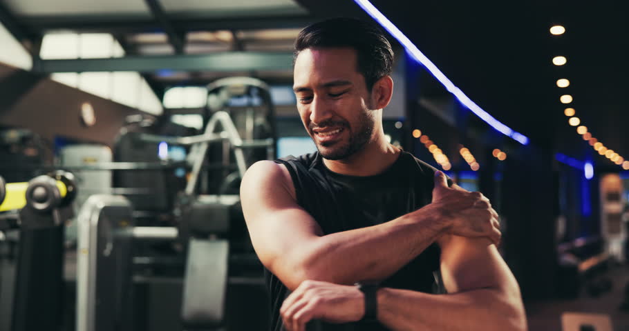 Man, shoulder pain or injury in gym with muscle tension, cramps or joint ache with athlete workout. Arm, inflammation or exercise with discomfort, fibromyalgia or stretching strain at fitness center