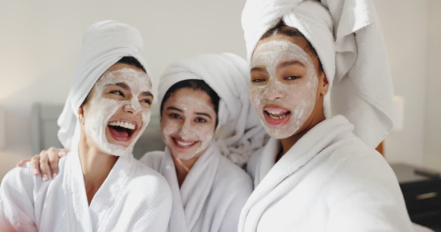 Friends, girls and selfie with face mask at spa for pamper date memory, social media and bonding. Self care, people and laughing in hotel room for luxury skincare treatment, holiday vlog or blow kiss