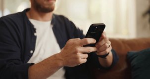 Hands, phone and man on sofa in home with networking, contact or social media scrolling. Notification, technology and male person with cellphone for connectivity, online or mobile app in living room. - Powered by Shutterstock - Get 15% off with code: PIKWIZARD15