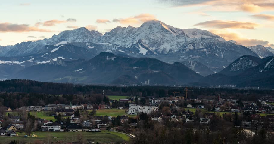 Salzburg, Austria - December 21, 2024: Mountain panorama at sunset viewed from Richterhöhe in Salzburg. Timelapse, slide transition.