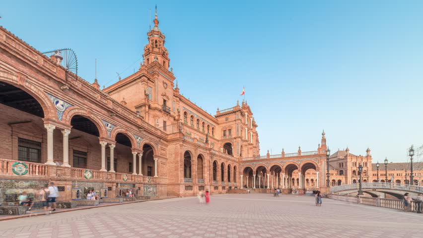 Plaza de Espana in Seville timelapse hyperlapse, a grand architectural complex in Maria Luisa Park built for the Ibero-American Exposition. Bridges and vintage streetlights during sunset