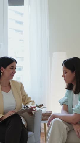 Psychologist comforting her patient during therapy session