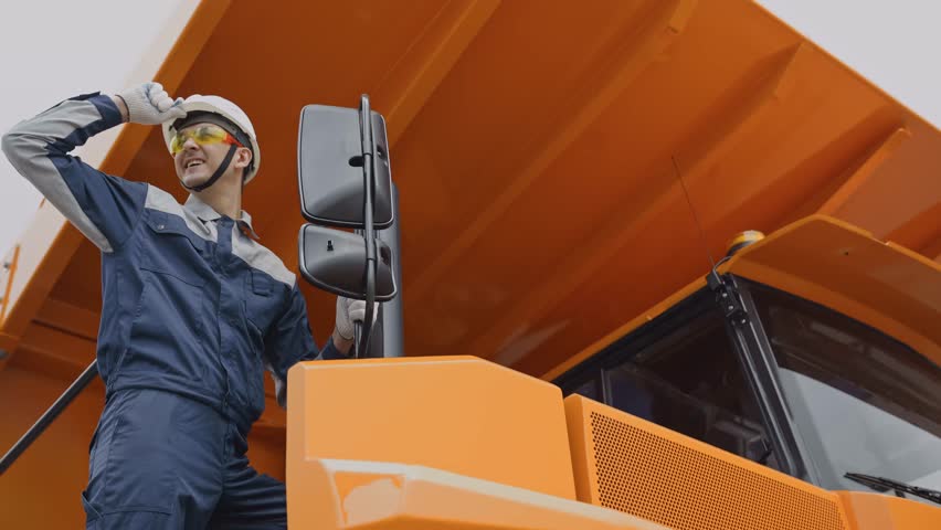 Portrait driver of mining truck worker in heavy machinery, teamwork and safety in action on open pit mine.