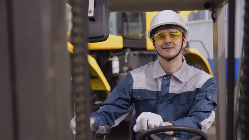 Skilled forklift operator maneuvers vehicle safely in warehouse environment.