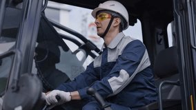 Man driver builder operate crane or excavator at construction site with sun light. Portrait Industry worker. - Powered by Shutterstock - Get 15% off with code: PIKWIZARD15