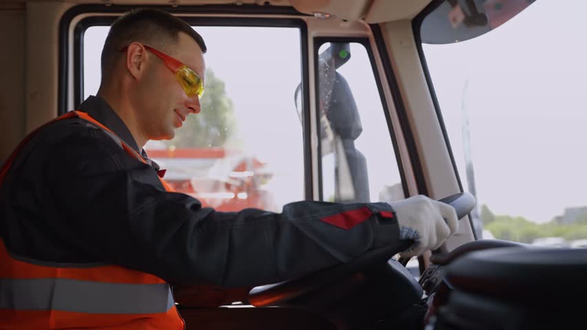Man driver of truck or mining lorry at construction site, Portrait Industry worker.