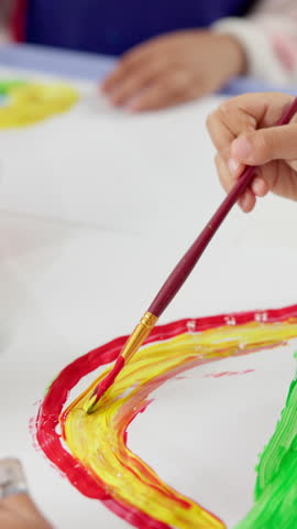 Painting, brush and hands of child in classroom at preschool for activity, hobby or cognitive development. Fun, student and closeup of kid with art for creative, poster or sign at elementary academy.