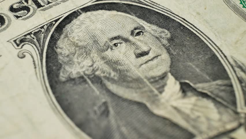 One dollar bill from 1963, featuring George Washington portrait. Detailed shot captures unique elements of US currency. Concept of currency issued by the government to represent wealth in society