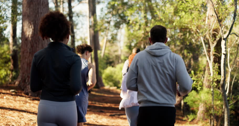 Fitness, people and group running in woods for marathon practice, endurance and outdoor trail. Cardio club, back and jog together in forest for competition, exercise and pace training for performance