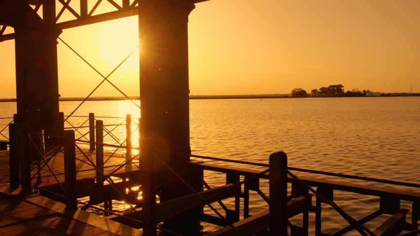 Sunset illuminates the industrial pier of Muelle de Rio Tinto, Huelva, Andalucia, Spain
