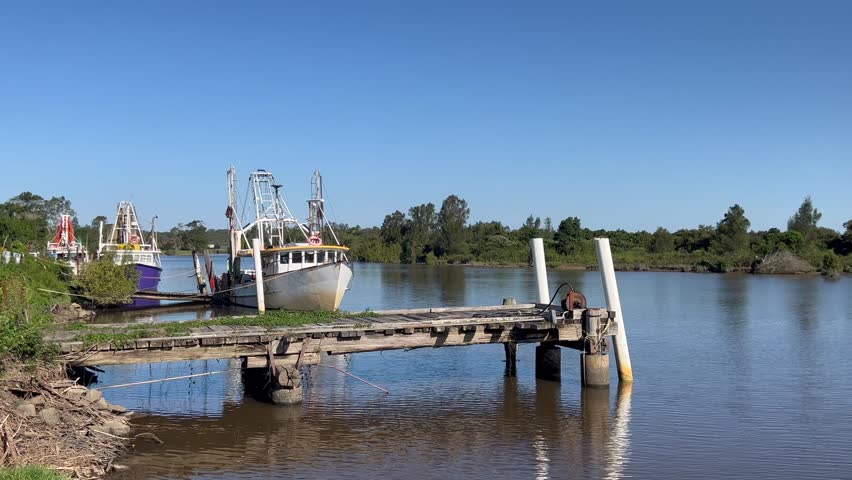 Traditional fishing boats moor on Macleay River New South Wales Australia