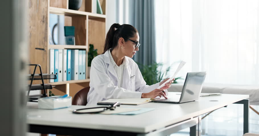 Doctor, woman and laptop with document in clinic for medical journal, research or telehealth. Healthcare, report or typing with paperwork in hospital for administration, management or problem solving