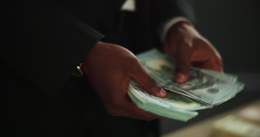 Hands, fraud and counting cash for money laundering, capital and investment scam in crime syndicate. Night, closeup and person with dollars from criminal activities, corruption or illegal business