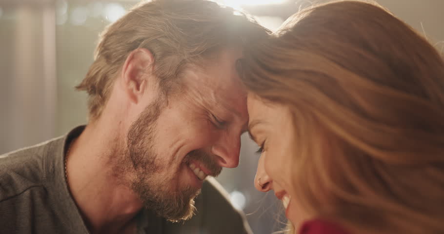 Smile, couple and forehead touch at house for romance, affection and connection of relationship. People, passionate and partner love for special moment, bonding together and commitment of marriage