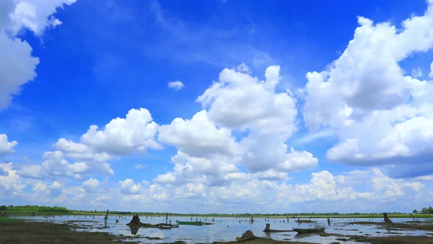 Scenic Landscape of Lake with Cumulus Clouds and Boats