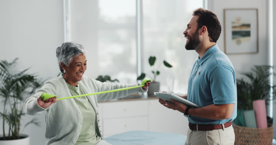 Physiotherapy, resistance band and high five with senior woman for fitness goal. Physical therapy, stretch and happy chiropractor on tablet for success, rehabilitation or celebrate health improvement