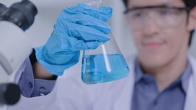 Asian Researcher using a microscope in the clinical lab.male Researcher working in the clinical laboratory,Medical or scientific researcher or Asian man doctor looking at professional microscope. - Powered by Shutterstock - Get 15% off with code: PIKWIZARD15