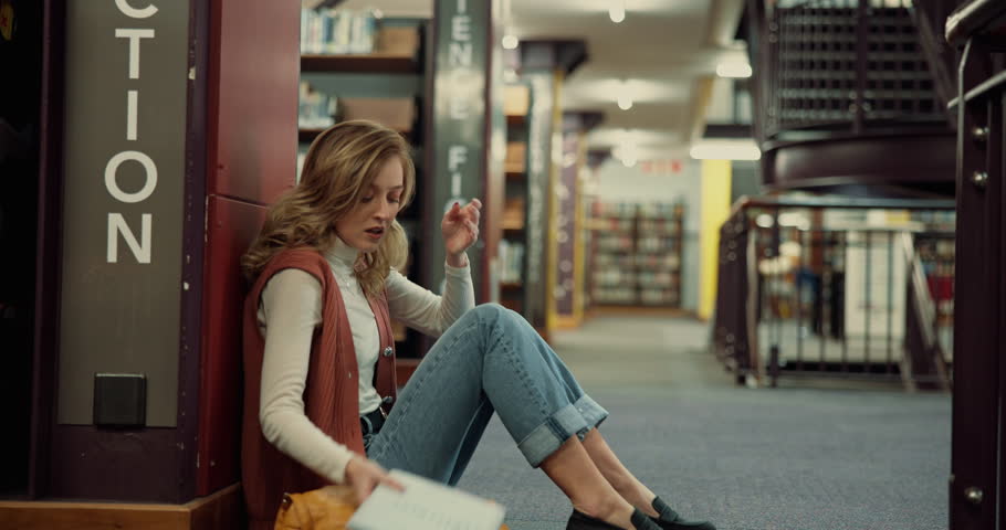 Stress, student and woman with anxiety in library, exam pressure or fail test in college. University, sad or unhappy girl overwhelmed with assignment deadline, burnout or think with worry for results