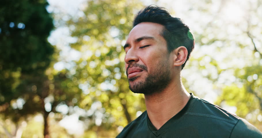Fitness, happy and man in nature for thinking with workout, health or training for wellness. Low angle, sports and athlete with preparing for exercise outdoor in park with breathing for warm up.