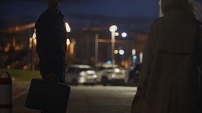 Secret late-night exchange between secret agents, man and woman in empty urban parking garage. Man hands over a large suitcase, receiving a folder in return. Confidential deal, crime, or espionage - Powered by Shutterstock - Get 15% off with code: PIKWIZARD15