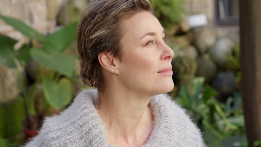 Beautiful Mature Caucasian Woman Sits in Garden Enjoying Fresh Air CU