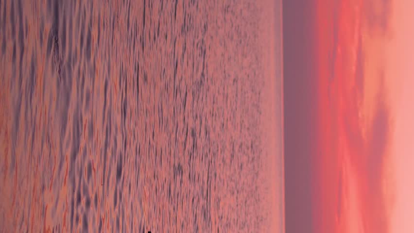 Vertical, Bright Colorful Sunset Over Sea Fairy Pink Red Orange Lilac Sky Sun Light Clouds. Amazing Bay, Calm Ocean Beautiful Sunrise Sky Relax Planet Travel Nobody Beach Seashore Background Horizon