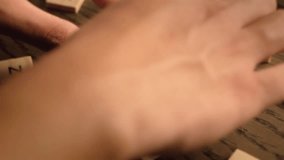 A hand arranges wooden letter tiles to spell love - Powered by Shutterstock - Get 15% off with code: PIKWIZARD15