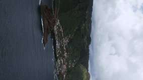 Aerial view of Porto Moniz, houses, volcanic islet and coastline in Madeira Island, Portugal. Vertical Video - Powered by Shutterstock - Get 15% off with code: PIKWIZARD15