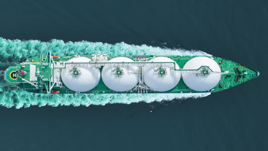 Aerial top view LNG Tanker ship (Liquified Natural Gas) with contrail in the ocean sea ship carrying container and running for export from container international port to custom ocean
