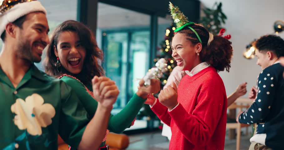 Dance, happy and friends at christmas party with music for fun, celebration or festive season. Laugh, event and group of people with xmas playlist for groove together with holiday song in home.