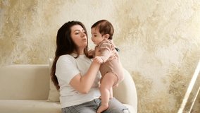 baby and mother, mom hugging baby at home, maternal love and care, mom with a small child, brown or beige background - Powered by Shutterstock - Get 15% off with code: PIKWIZARD15