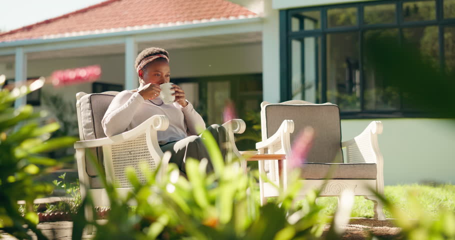 Coffee, outdoor and black woman relax in backyard for calm, peace and break on weekend by home. Smile, thinking and female African person with cappuccino, latte or espresso in garden with drink