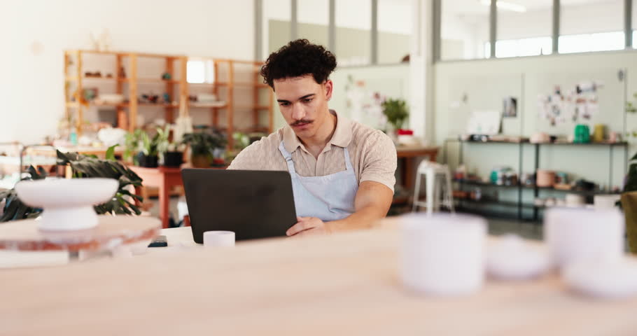 Man, creative and laptop in startup for ceramics, inventory management or clay order. Small business, sculptor or artisan entrepreneur in workshop for pottery sales, craft checklist or stock supply