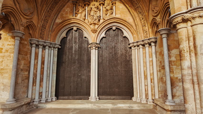 Detailed stone carvings and slender pinnacles adorn the west front of Salisbury Cathedral, Salisbury, Wiltshire, England, UK
