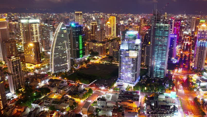Aerial skyline of Downtown Taichung, a vibrant metropolis in central Taiwan, with modern high-rise office towers booming in the 7th Redevelopment Zone and city lights dazzling at night (in hyperlapse)